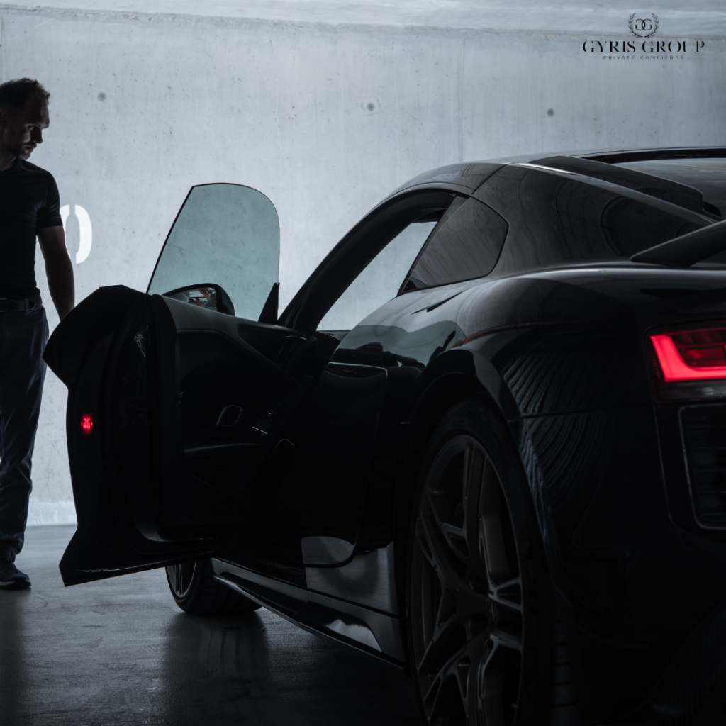 a man opening a luxury car in a parking