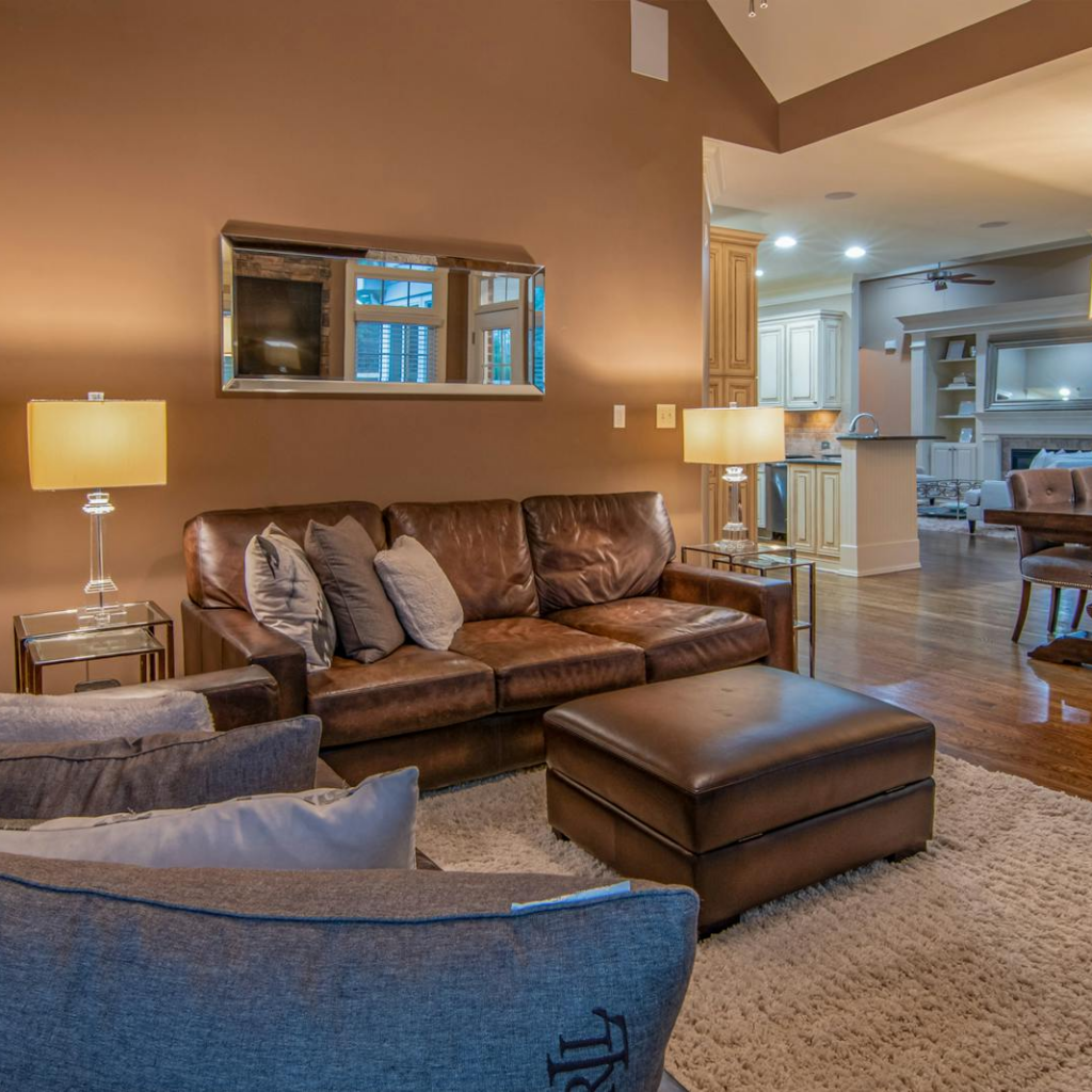 Spacious living room with modern furniture and warm lighting for a cozy atmosphere.