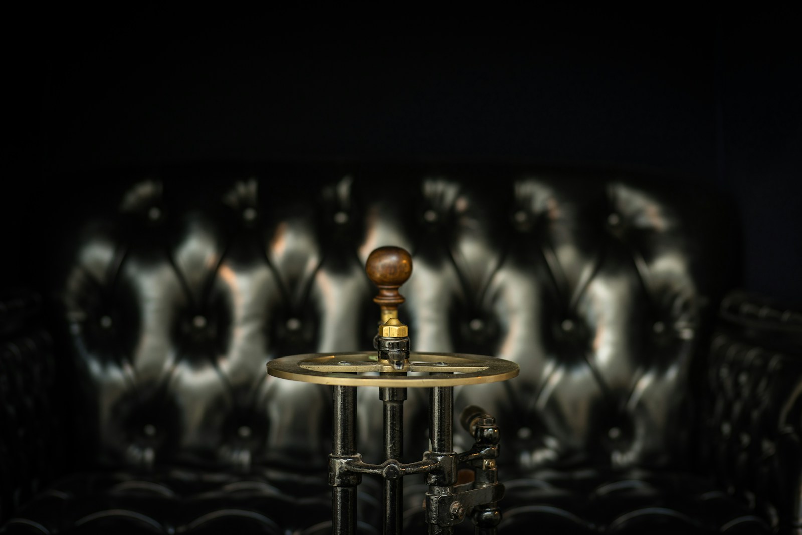 closeup photo of crank tool beside sofa